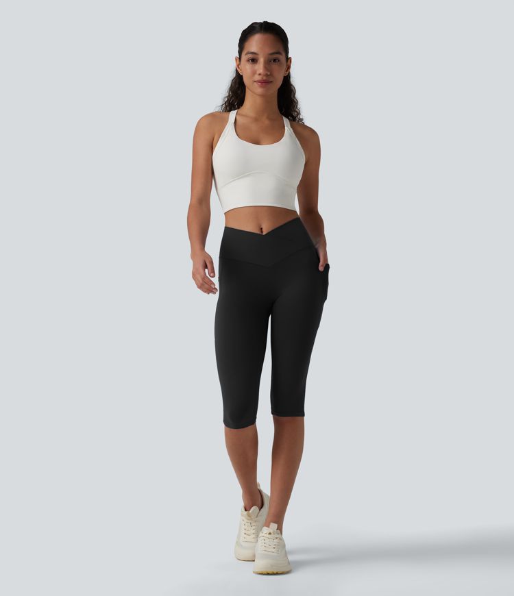 SoftlyZero™ leggings de yoga de talle alto con cinturilla cruzada, estilo pedal‑pusher, con bolsillos — UPF50+