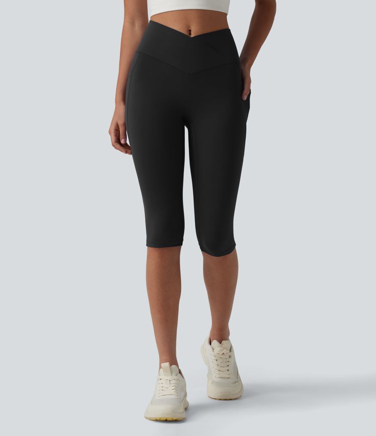 SoftlyZero™ leggings de yoga de talle alto con cinturilla cruzada, estilo pedal‑pusher, con bolsillos — UPF50+