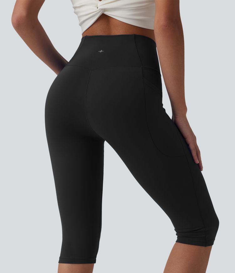 SoftlyZero™ leggings de yoga de talle alto con cinturilla cruzada, estilo pedal‑pusher, con bolsillos — UPF50+