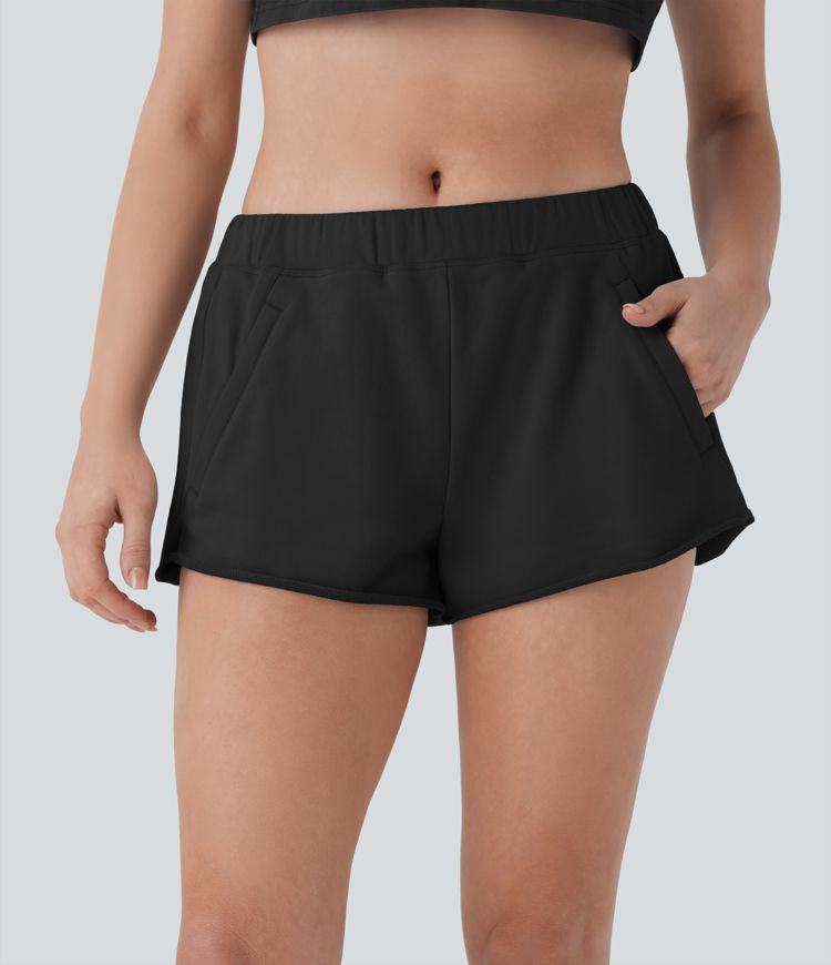 Short de yoga en coton taille mi-haute à poches zippées et ourlet brut
