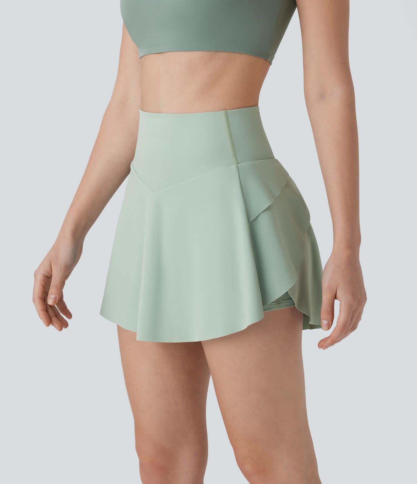 2-in-1 Mini-Tennisrock mit hohem Bund, Tasche und Bauchkontrolle