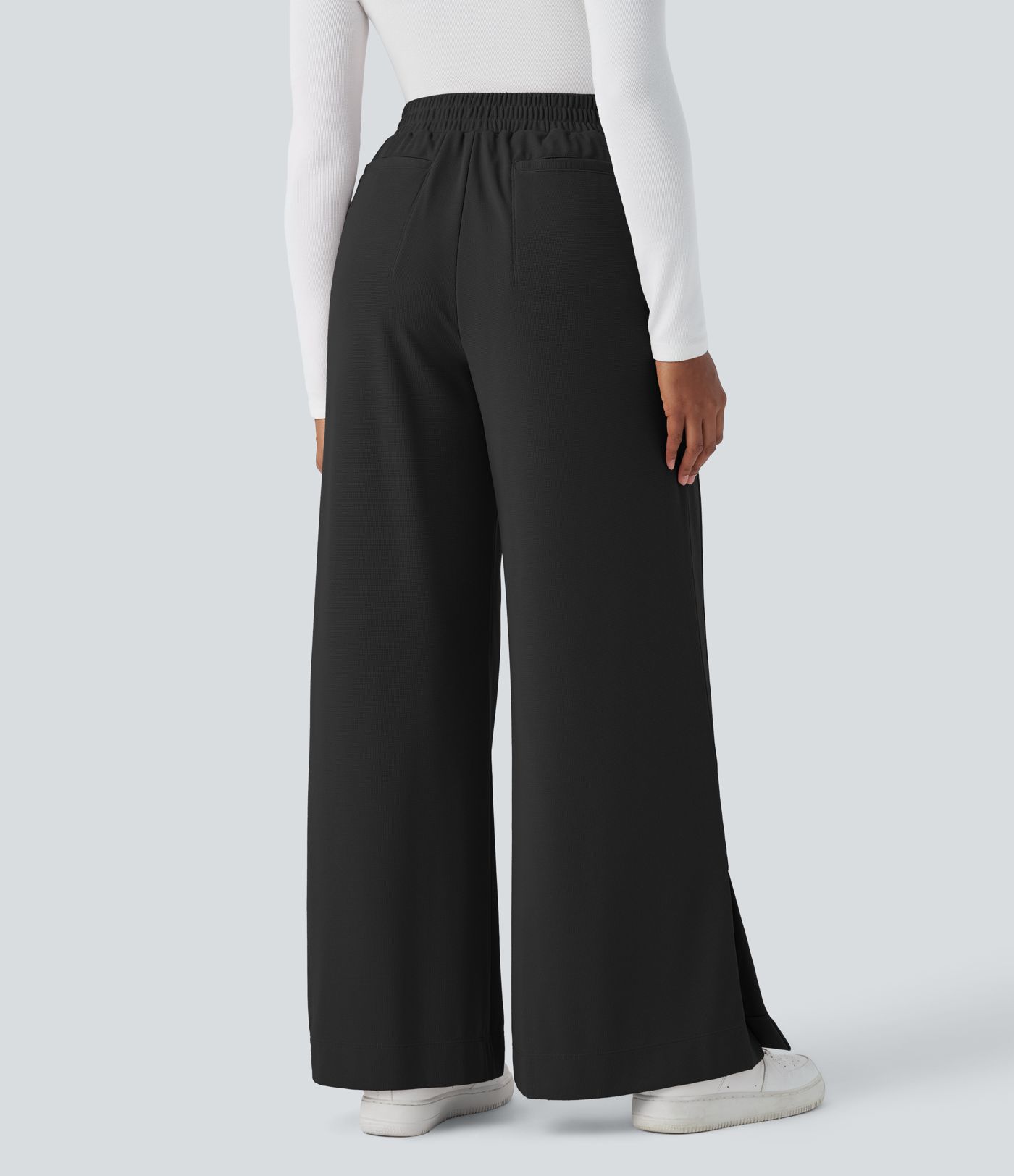 Pantalón gofre pierna ancha abertura bolsillo lateral cremallera plisada tiro alto