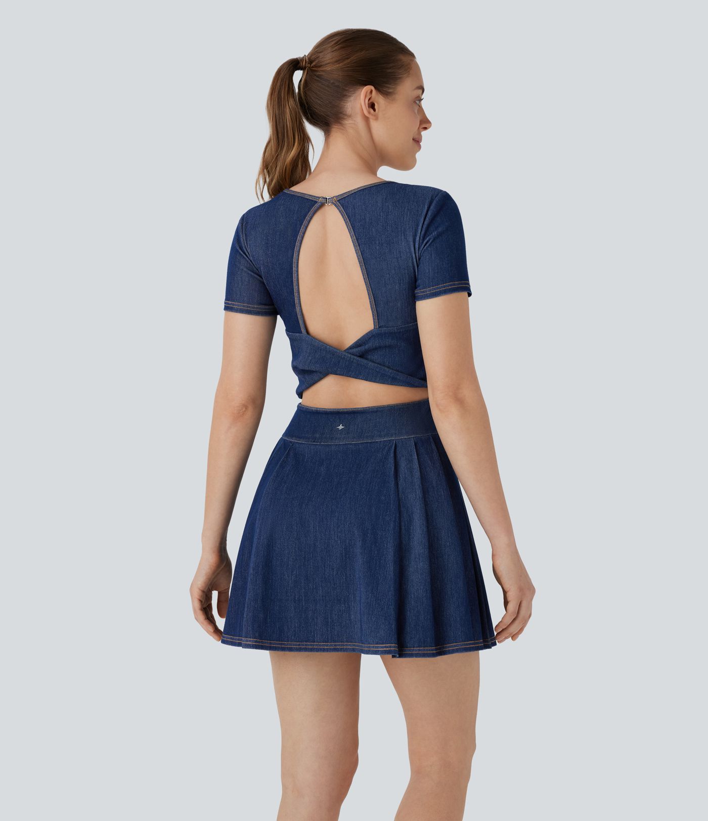 Halara Flex™ Backless, twisted, pleated 2-in-1 tennis active dress made from washed, stretchy knit denim with pockets