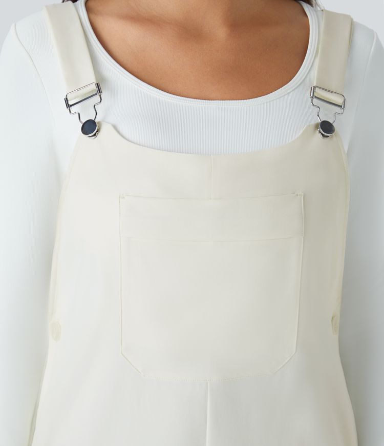 Adjustable strap with water-resistant and abrasion-resistant properties, multiple pockets, button closure, outdoor overall.