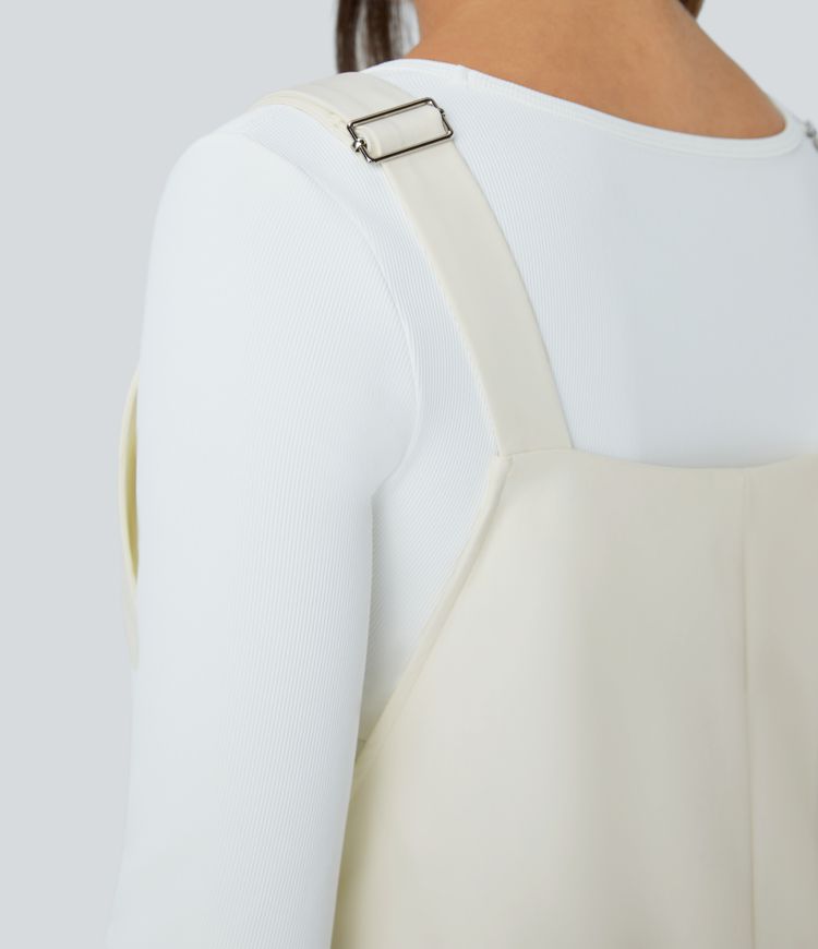 Adjustable strap with water-resistant and abrasion-resistant properties, multiple pockets, button closure, outdoor overall.