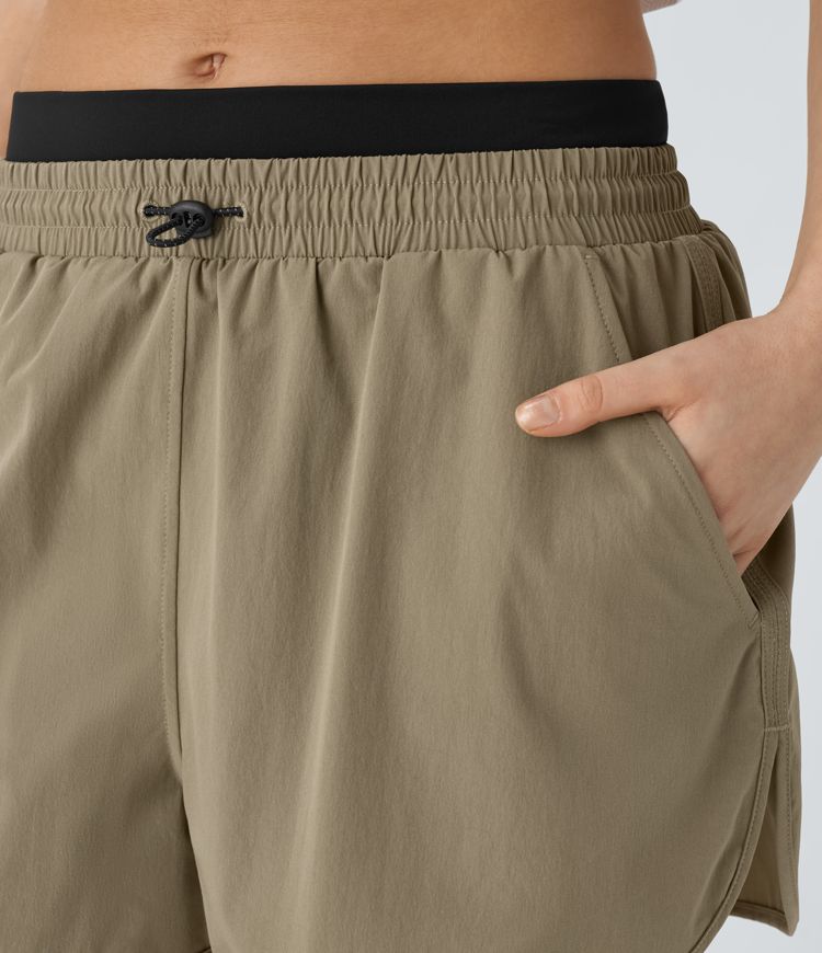 Mittlere Steighöhe Farbblock reflektierende Taschen Gebogener Saum 2-in-1 Wandershorts