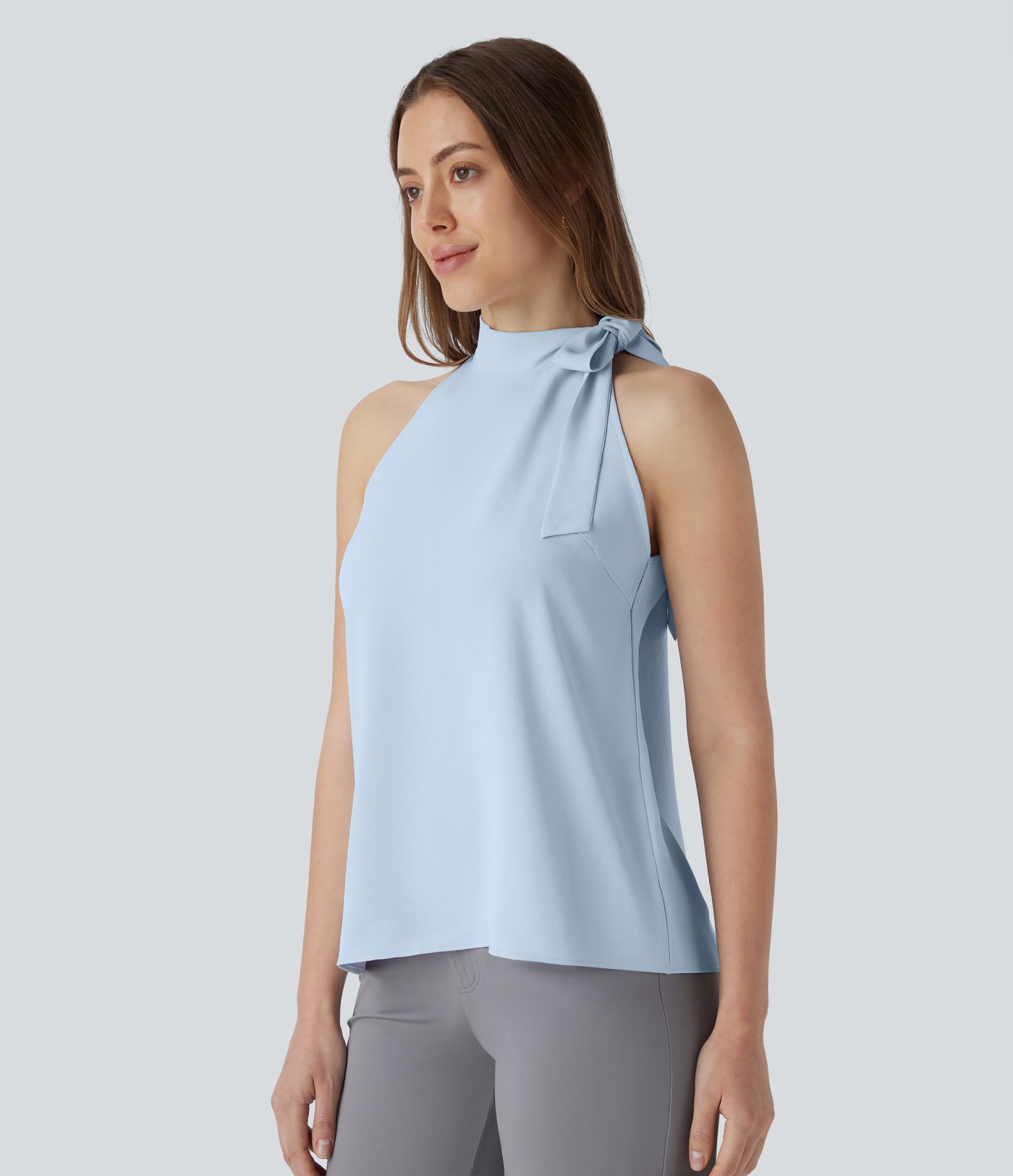 Blusa de oficina sin mangas con cuello halter y lazo decorativo