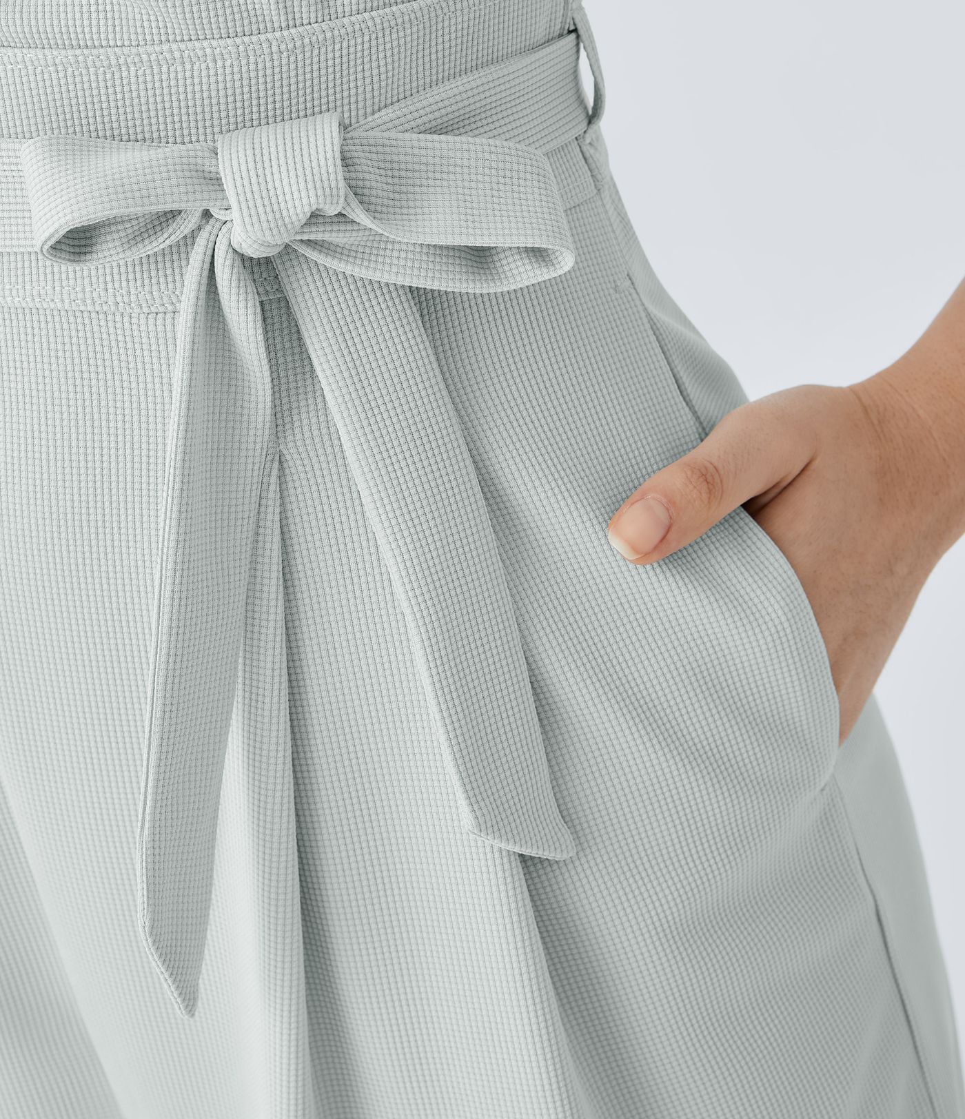 V-neck hidden zipper jumpsuit with belt, side pockets, and waffle texture for a casual look