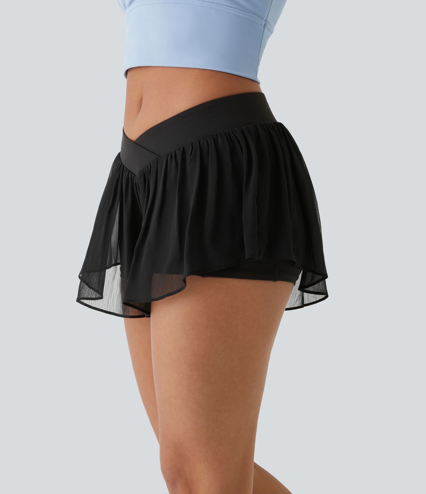 Pantalones cortos de yoga de tiro bajo con cruce, bolsillos y transparencia 2 en 1