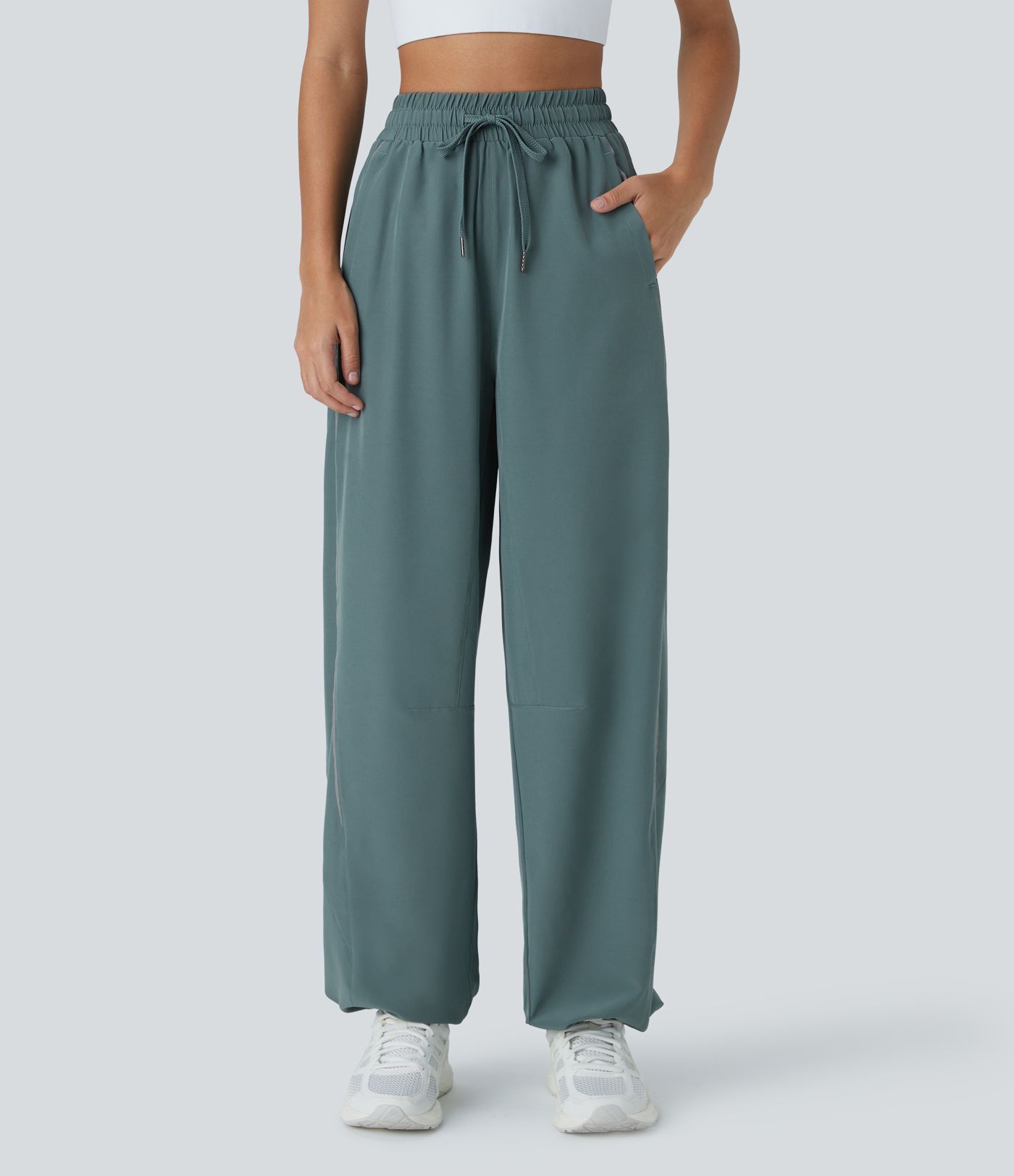 Pantalón correr tiro alto cordón ajustable bolsillo lateral dobladillo reflectante