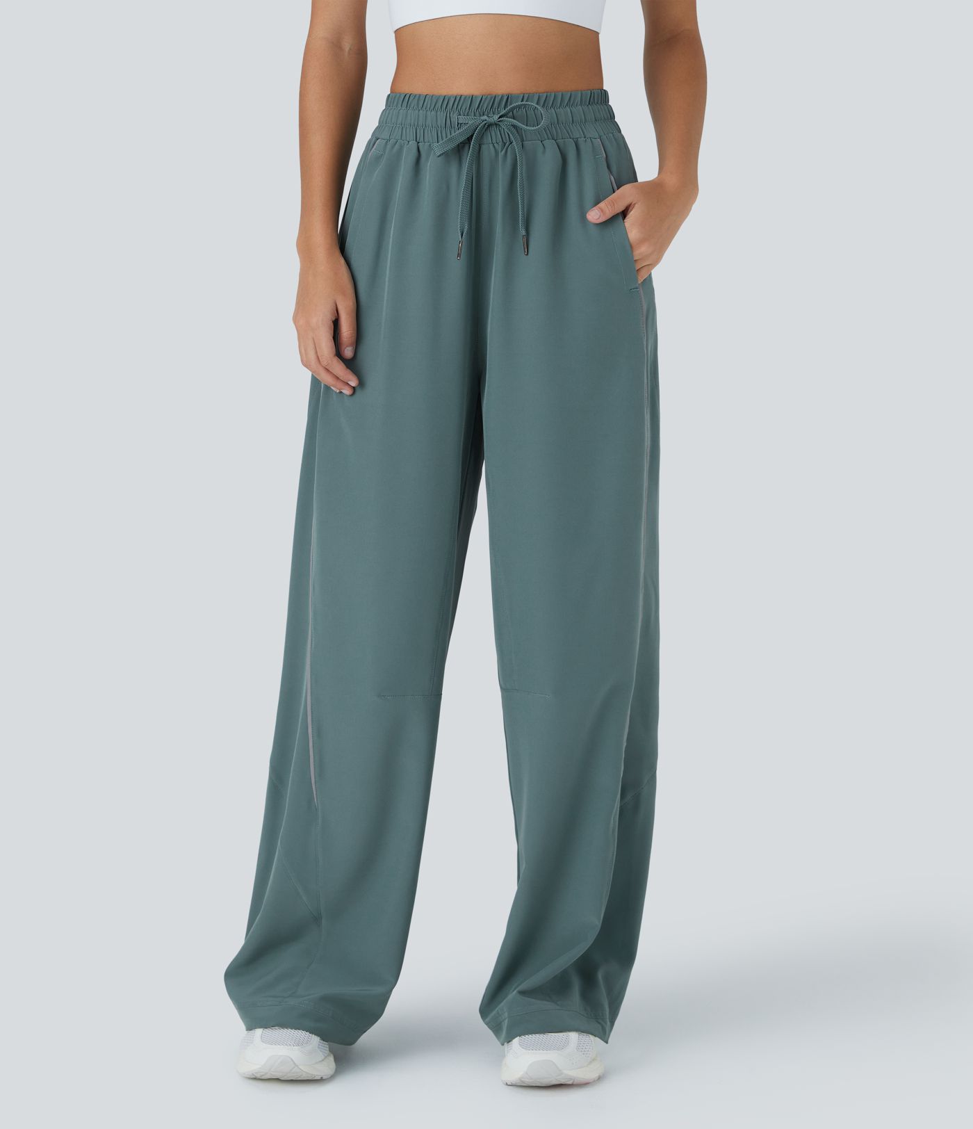 Pantalón correr tiro alto cordón ajustable bolsillo lateral dobladillo reflectante