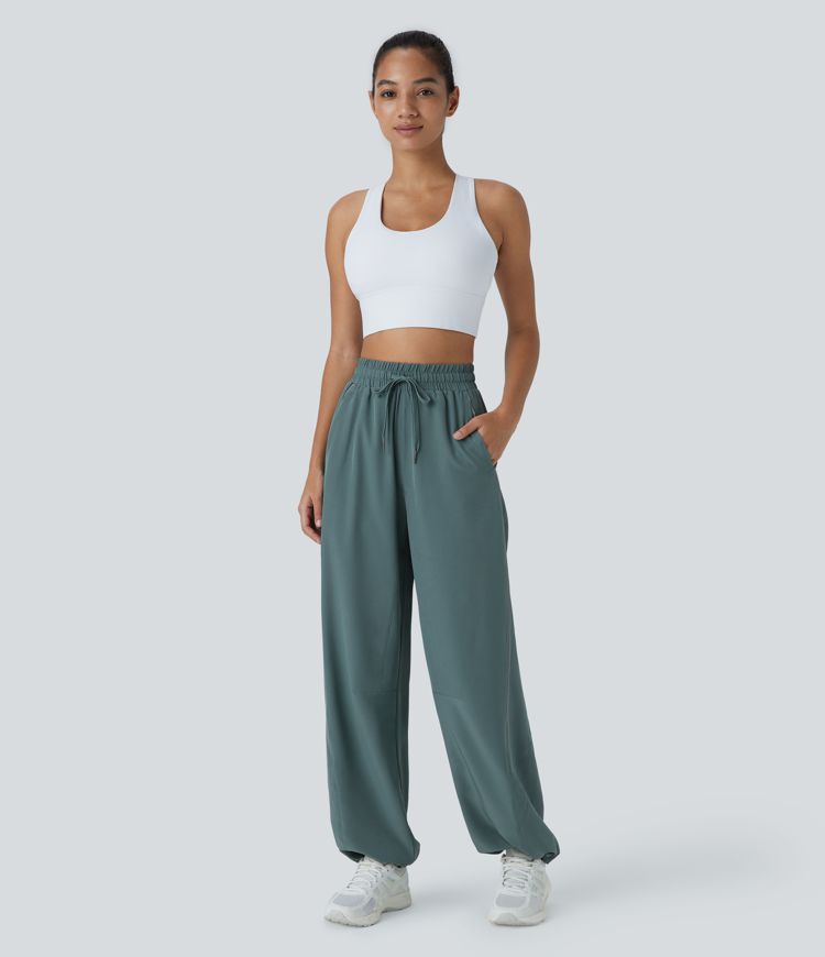 Pantalón correr tiro alto cordón ajustable bolsillo lateral dobladillo reflectante