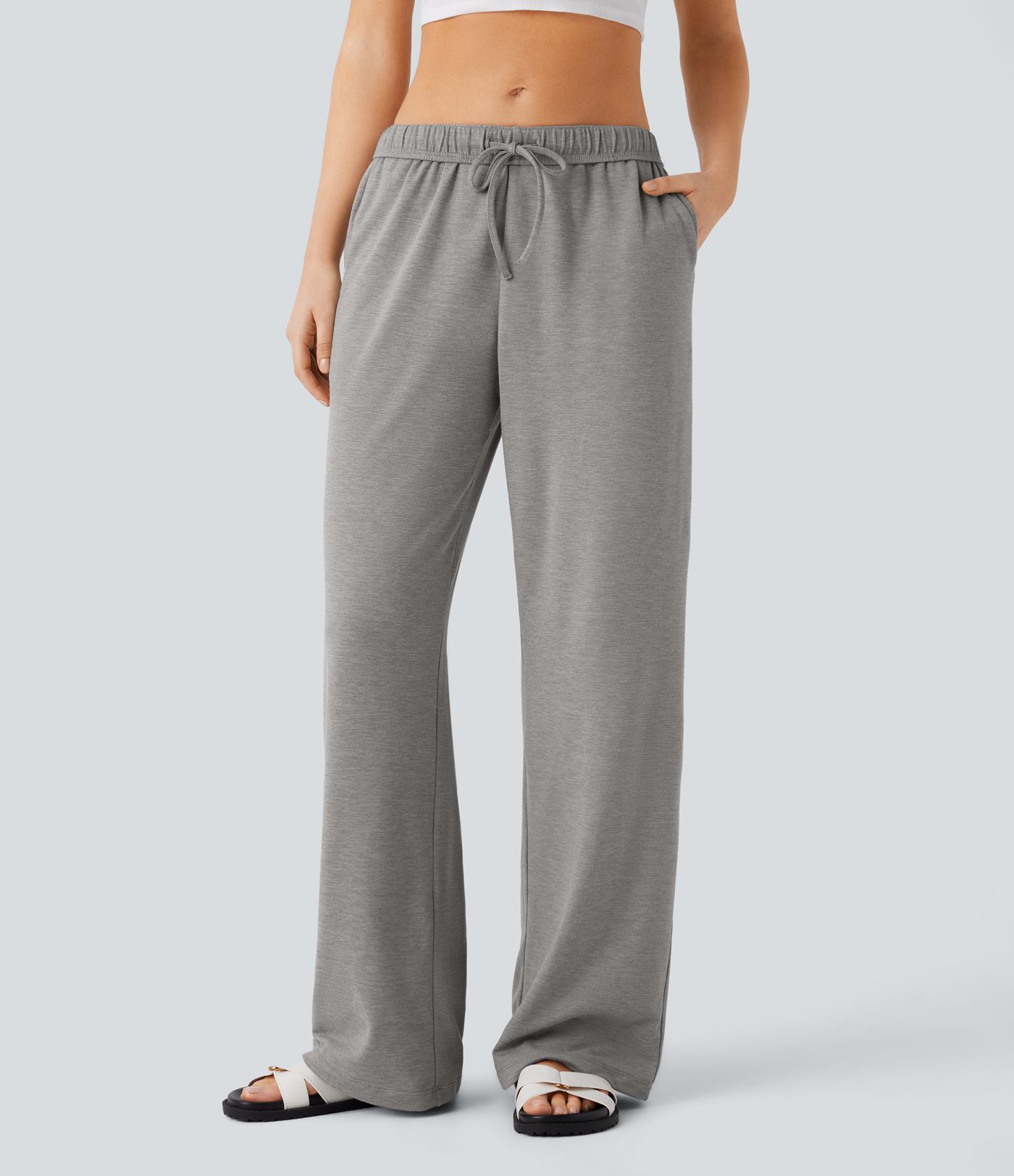 Pantalón tiro alto bolsillo lateral pierna recta dobladillo cordón