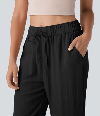 Stredne vysoké voľnočasové nohavice so zúženým strihom, so šnúrkami a vreckami