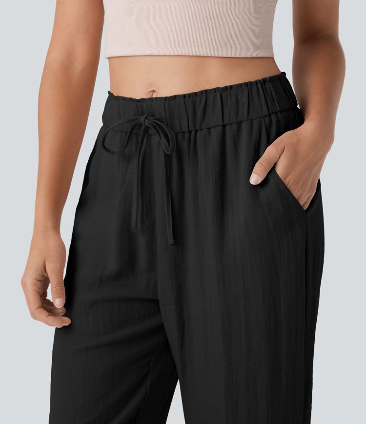 Stredne vysoké voľnočasové nohavice so zúženým strihom, so šnúrkami a vreckami