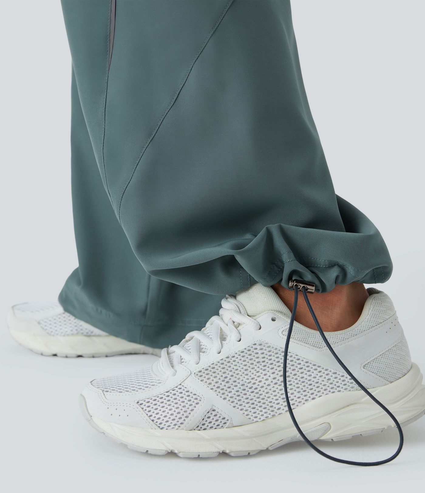 Pantalón correr tiro alto cordón ajustable bolsillo lateral dobladillo reflectante