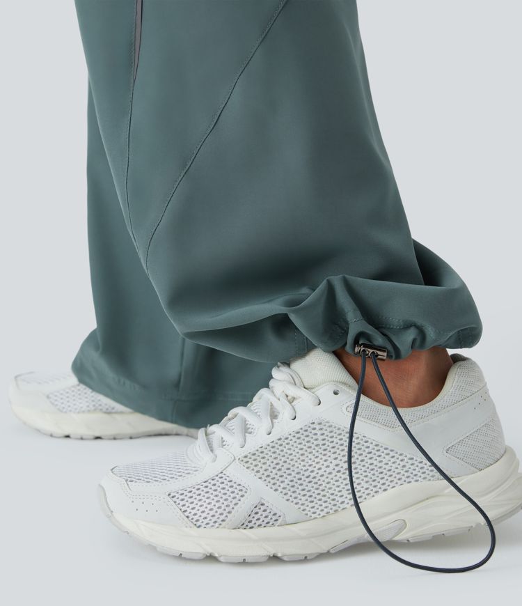 Pantalón correr tiro alto cordón ajustable bolsillo lateral dobladillo reflectante