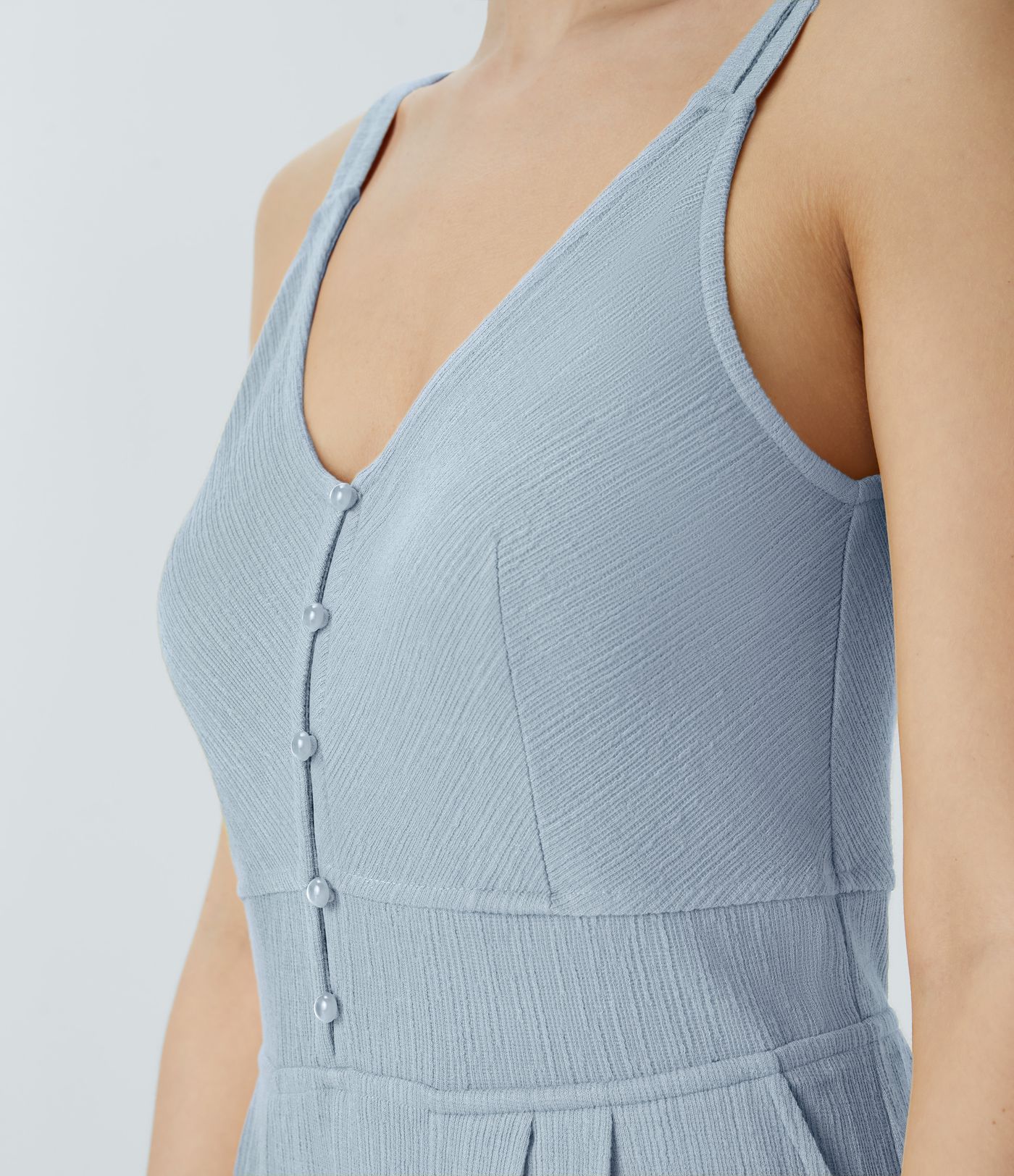 Casual flared jumpsuit with V-neck, double straps, buttons and side pockets