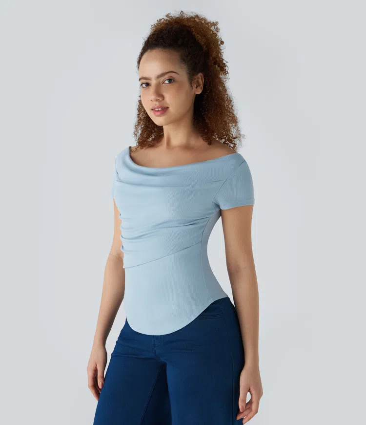 Ribbed knit boatneck top with pleated detail, curved hem, and skinny fit - casual style