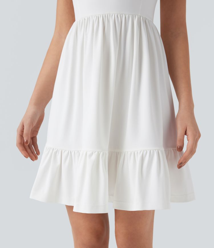 Mini dress with boat neck, low back, and bow