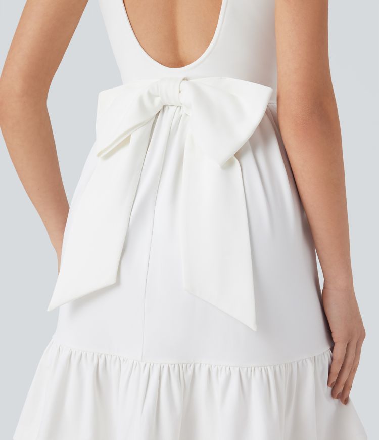 Mini dress with boat neck, low back, and bow