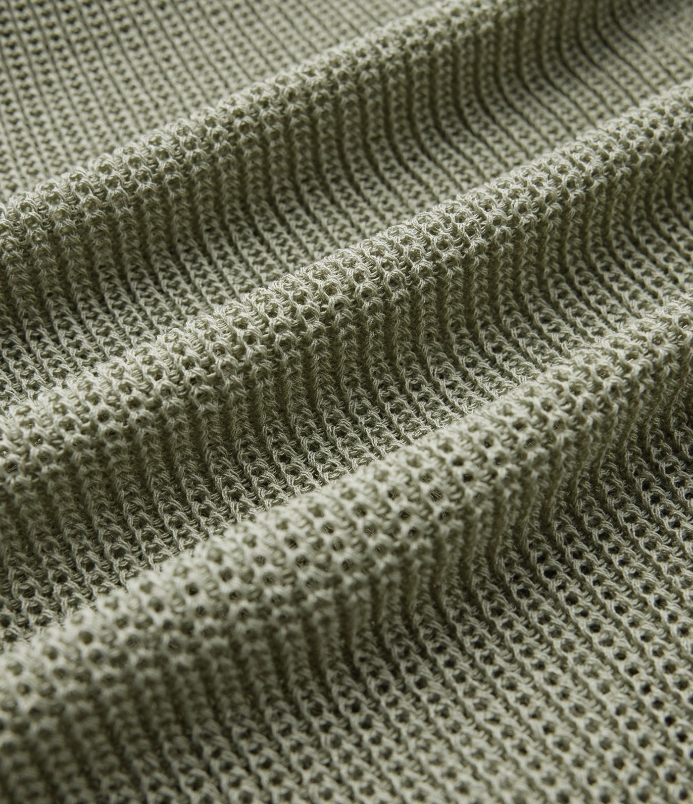 Jersey casual oversize de un hombro con media manga, abertura en el bajo y bolsillo