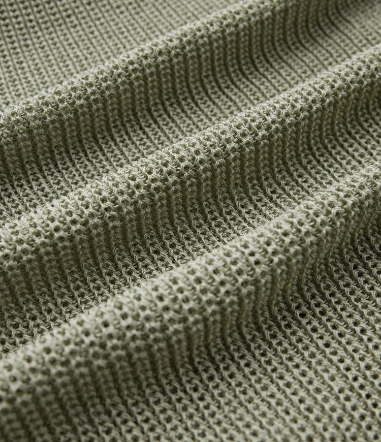 Jersey casual oversize de un hombro con media manga, abertura en el bajo y bolsillo