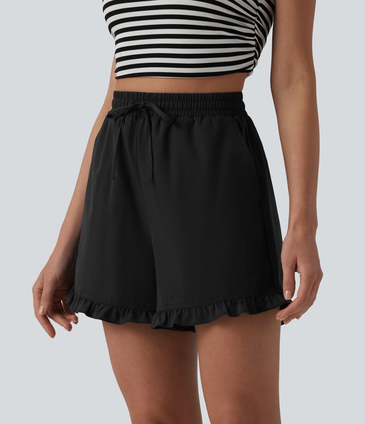 Kõrge vöökohaga, paelaga laiad vabaajashortsid volangiga ääre ja taskutega