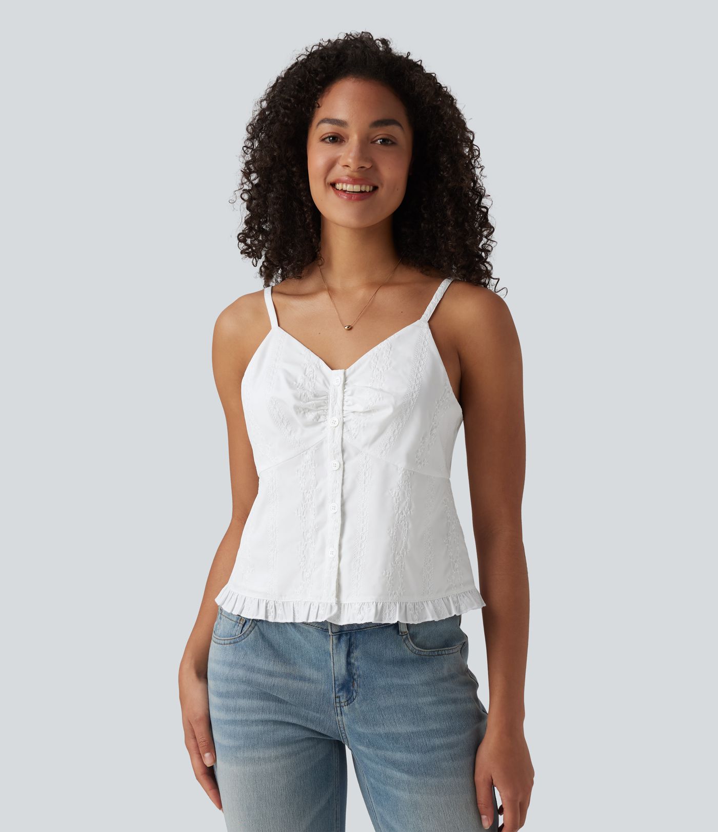 Top sin mangas estilo resort con escote en V, bordado y bajo con volante