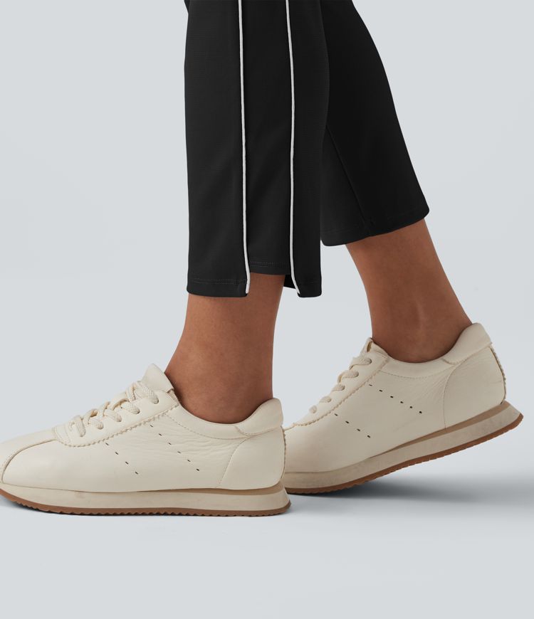 Schmal zulaufende Golfhose aus Krepp mit hohem Bund, Seitentaschen, reflektierenden Streifen und Golf-Tee-Taschen