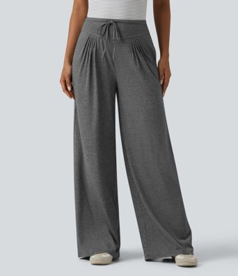 Pantalones casuales anchos de talle alto con cordón, plisados, de tejido jaspeado y con bolsillos.