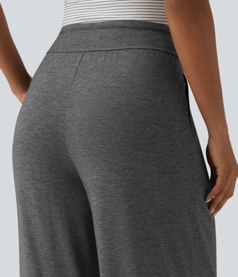 Pantalones casuales anchos de talle alto con cordón, plisados, de tejido jaspeado y con bolsillos.