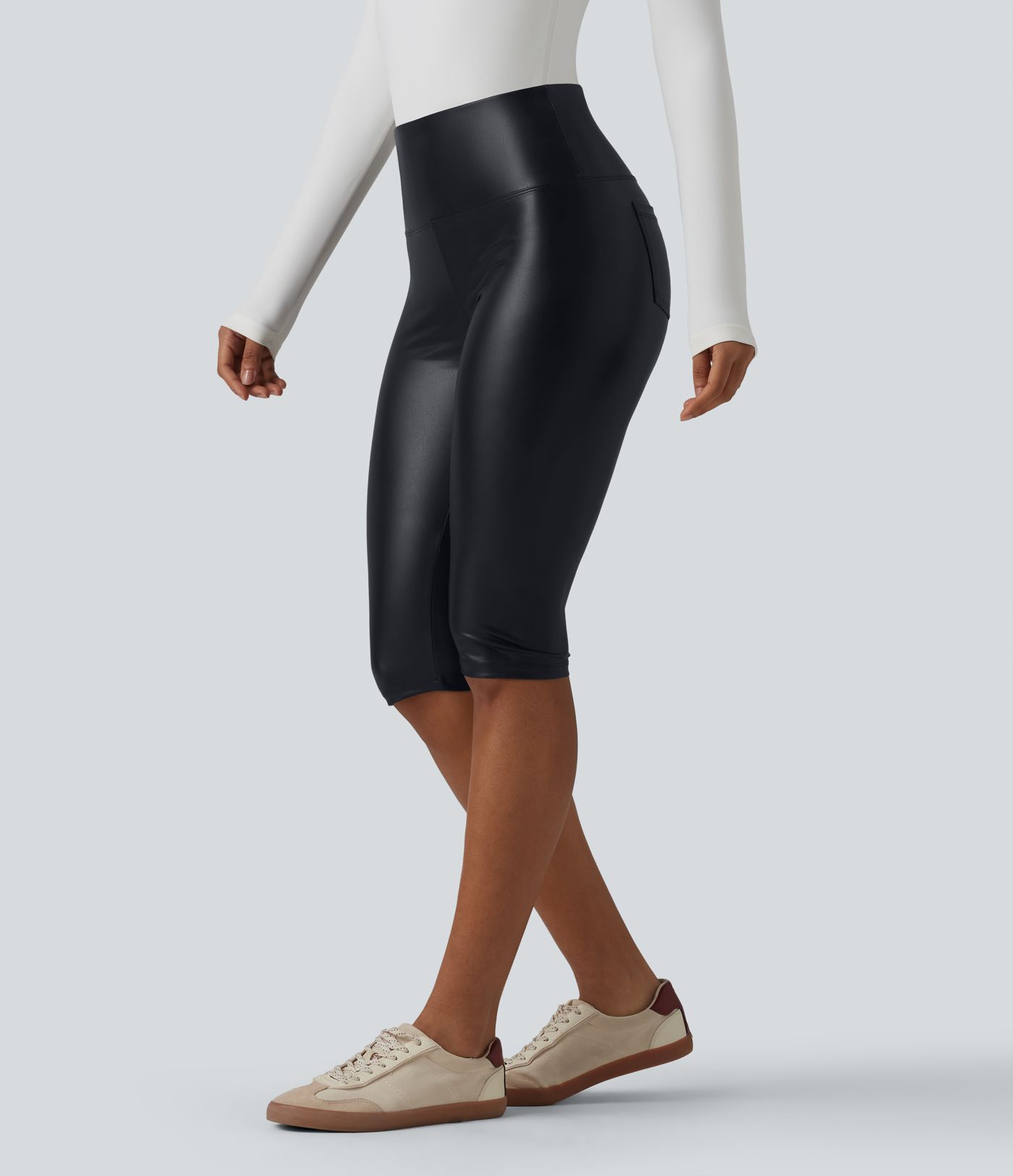 Casual high-waisted stretch cropped leggings in faux leather with pockets, designed to flatten the tummy and provide a flattering fit.