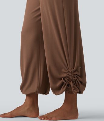 Gathered yoga joggers made from highly elastic ribbed knit with a high waistband, side pockets and drawstring.