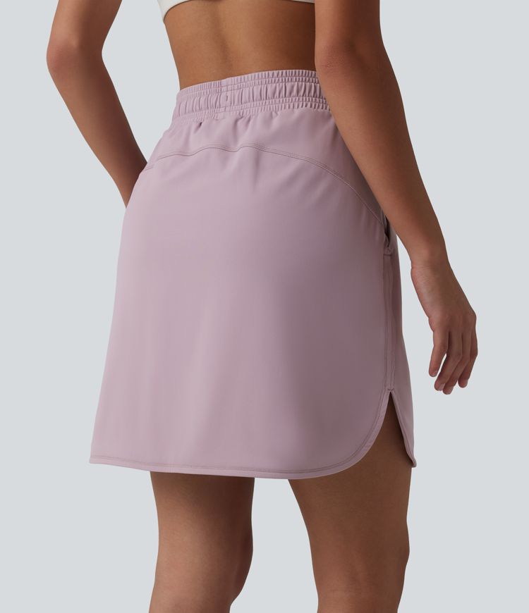 Jupe mini sport 2 en 1 Softlyzero™ Airy : taille mi-haute, poches latérales, cordon de serrage, tissu frais au toucher et ourlet arrondi.