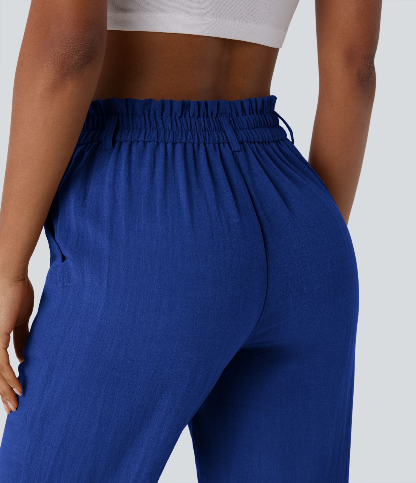Pantalón capri lino tiro alto bolsillo lateral cremallera botón