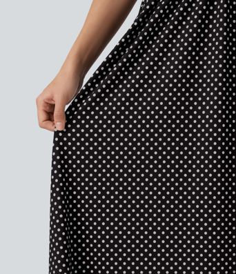 Robe midi fluide et décontractée à pois, sans manches, dos-nu et croisée, avec poches.