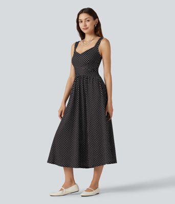 Robe midi fluide et décontractée à pois, sans manches, dos-nu et croisée, avec poches.