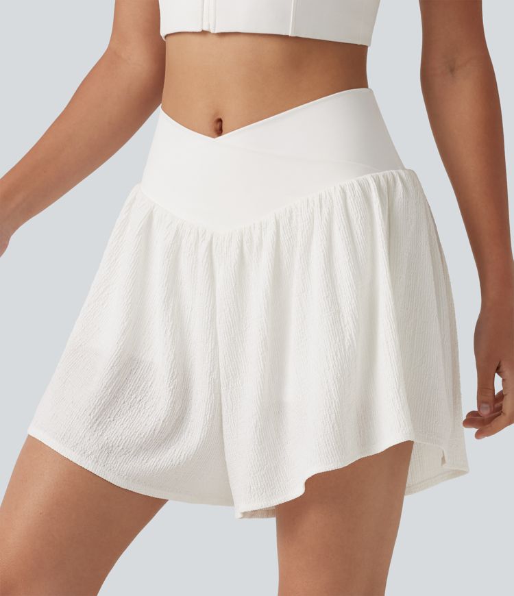 Crossover 2-in-1 Crinkle-Laufshorts mit hohem Bund, seitlichem Saumschlitz und Taschen