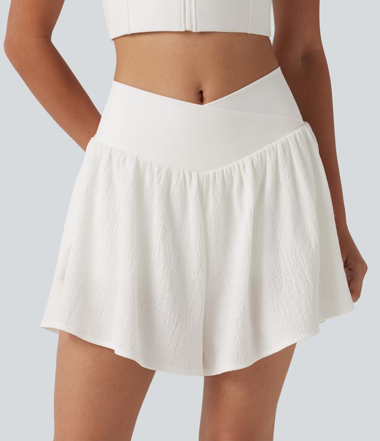 Crossover 2-in-1 Crinkle-Laufshorts mit hohem Bund, seitlichem Saumschlitz und Taschen