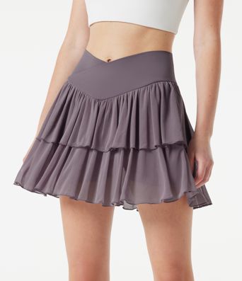 Falda mini de tenis 2 en 1 de malla a capas, cintura alta cruzada, de corte fluido, con bolsillos