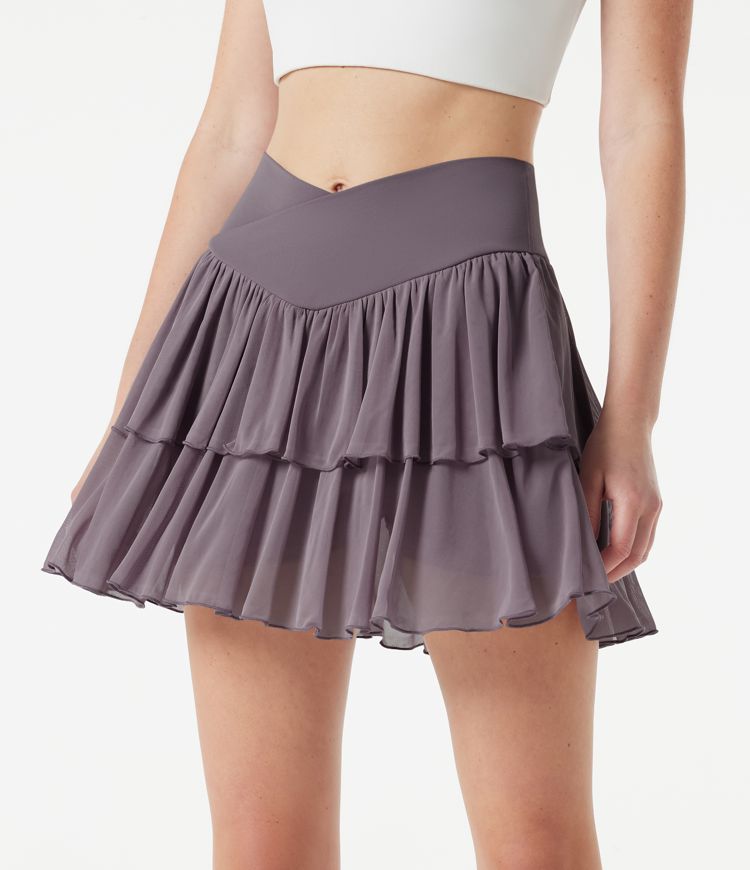 Falda mini de tenis 2 en 1 de malla a capas, cintura alta cruzada, de corte fluido, con bolsillos