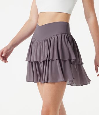 Falda mini de tenis 2 en 1 de malla a capas, cintura alta cruzada, de corte fluido, con bolsillos