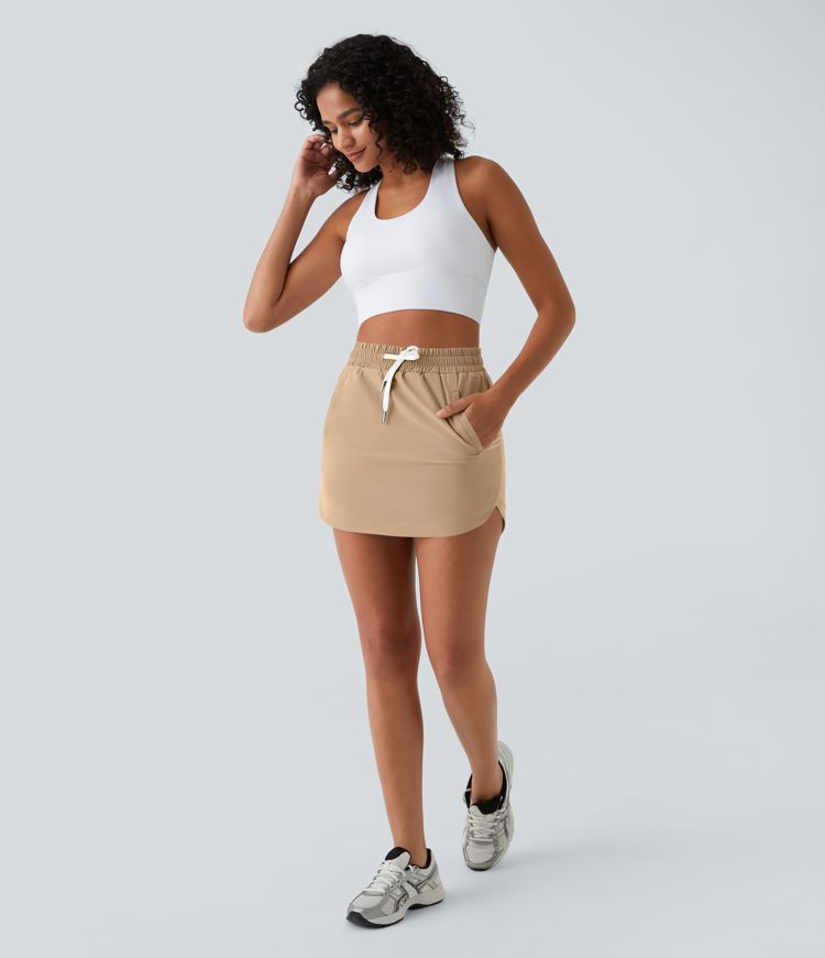Mini-Jupe Golf Taille Haute Cordon de Serrage Poches Latérales Ourlet Courbé 2 en 1 Mini-Jupe Golf Taille Haute Cordon de Serrage Poches Latérales Ourlet Courbé 2 en 1
