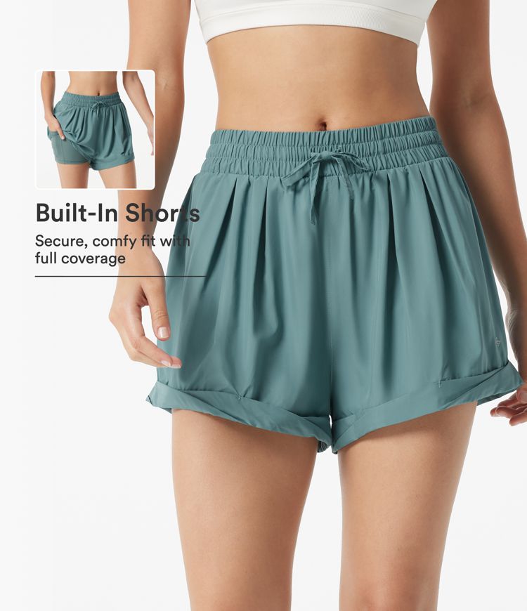 Baggy 2-in-1 Lauf-Shorts mit mittelhohem Bund, Seitentasche und Kordelzug Baggy 2-in-1 Lauf-Shorts mit mittelhohem Bund, Seitentasche und Kordelzug