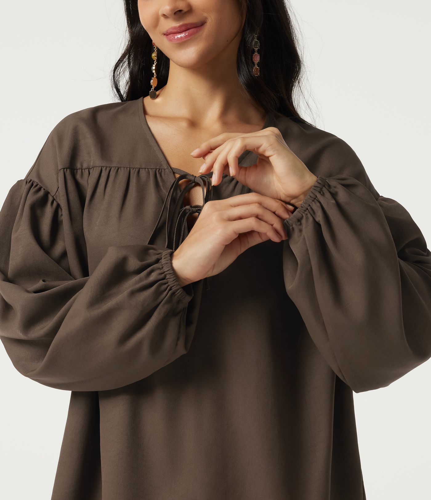 Casual blouse with V-neck, long sleeves, dropped shoulders, and a front lace-up Casual blouse with V-neck, long sleeves, dropped shoulders, and a front lace-up