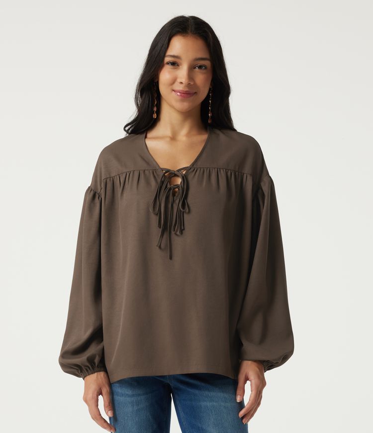 Casual blouse with V-neck, long sleeves, dropped shoulders, and a front lace-up Casual blouse with V-neck, long sleeves, dropped shoulders, and a front lace-up