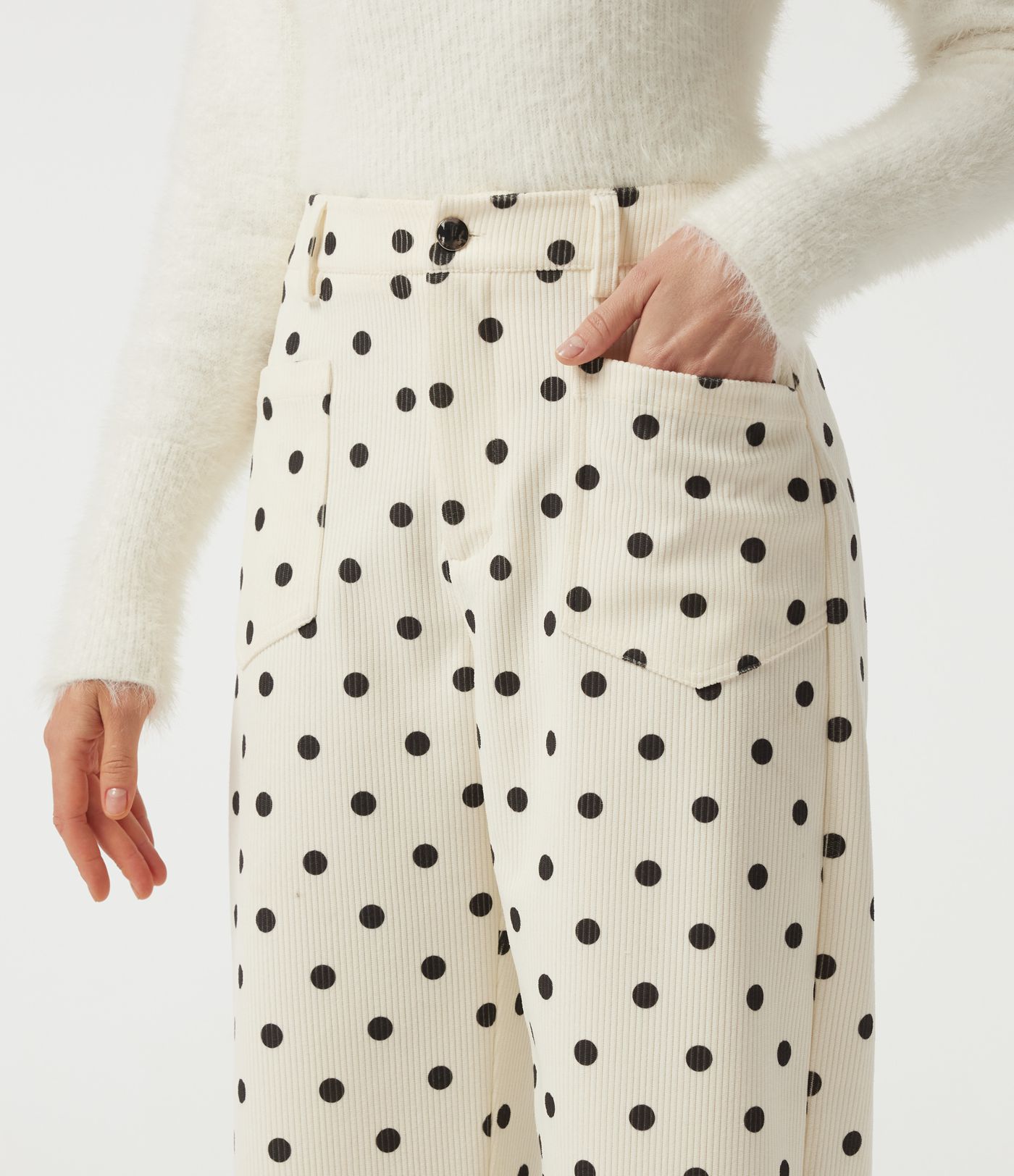 Mittelhohe Cordhose mit tonnenförmigem Bein, Pünktchenmuster und Taschen.